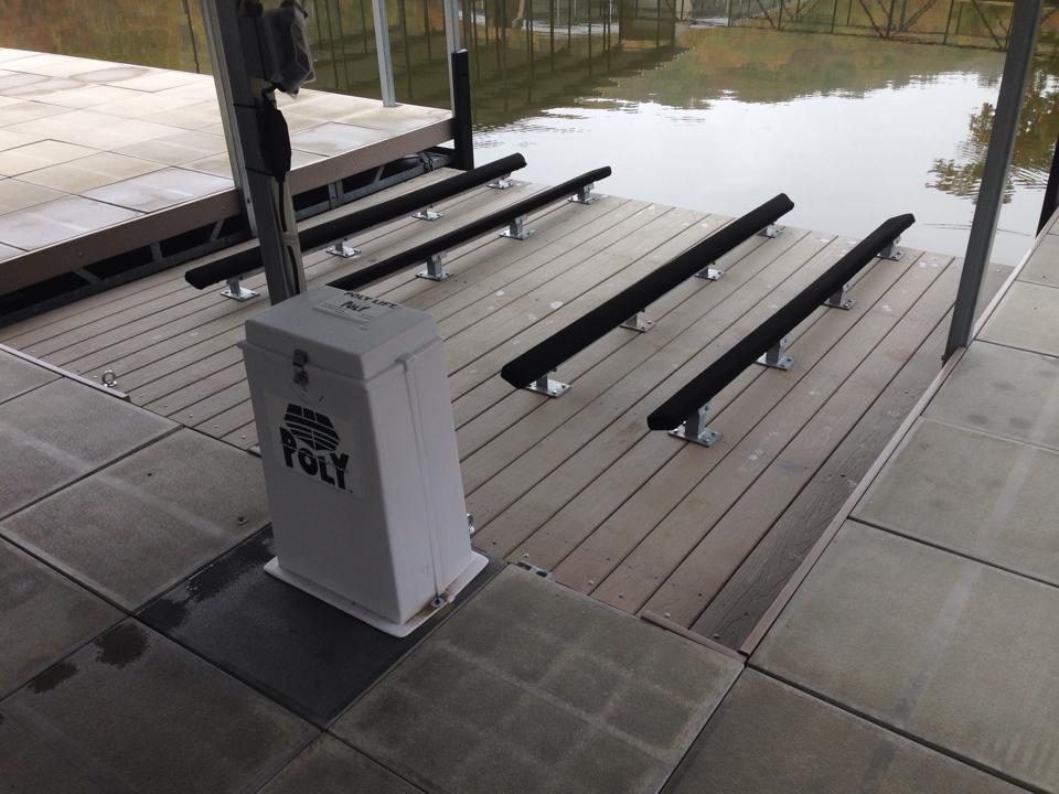 Photo of a PolyLift control panel on a dock and two boat slots