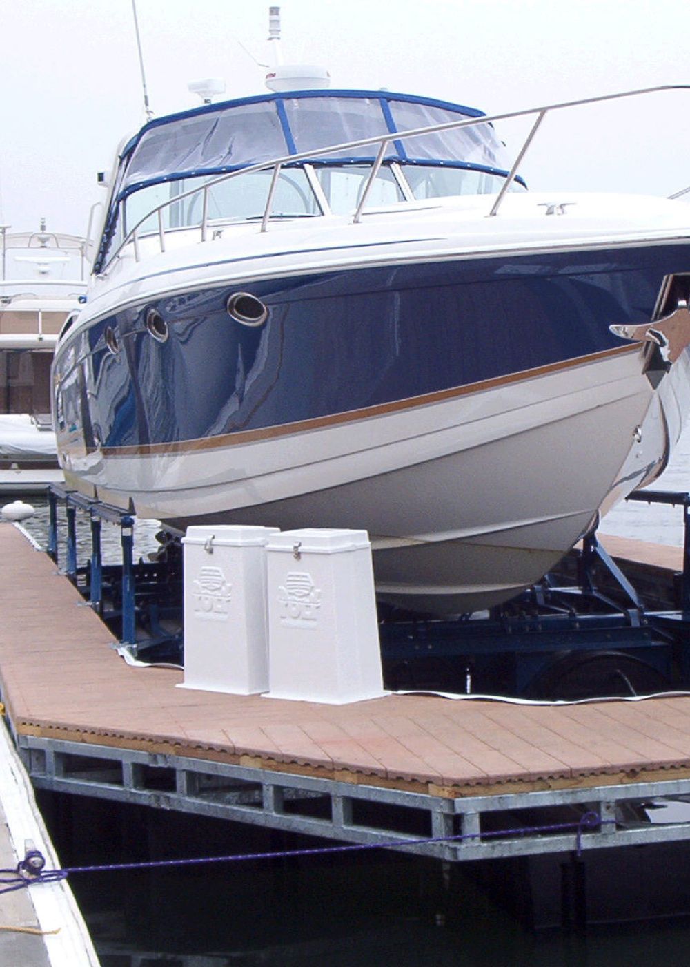 Photo of two PolyLIft control units in front of a boat