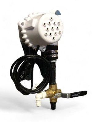 A close-up of a Poly Lift Manual Control Unit with a white, round, vented top, black coiled cable, and brass and plastic pipe fittings including a lever-style shut-off valve.